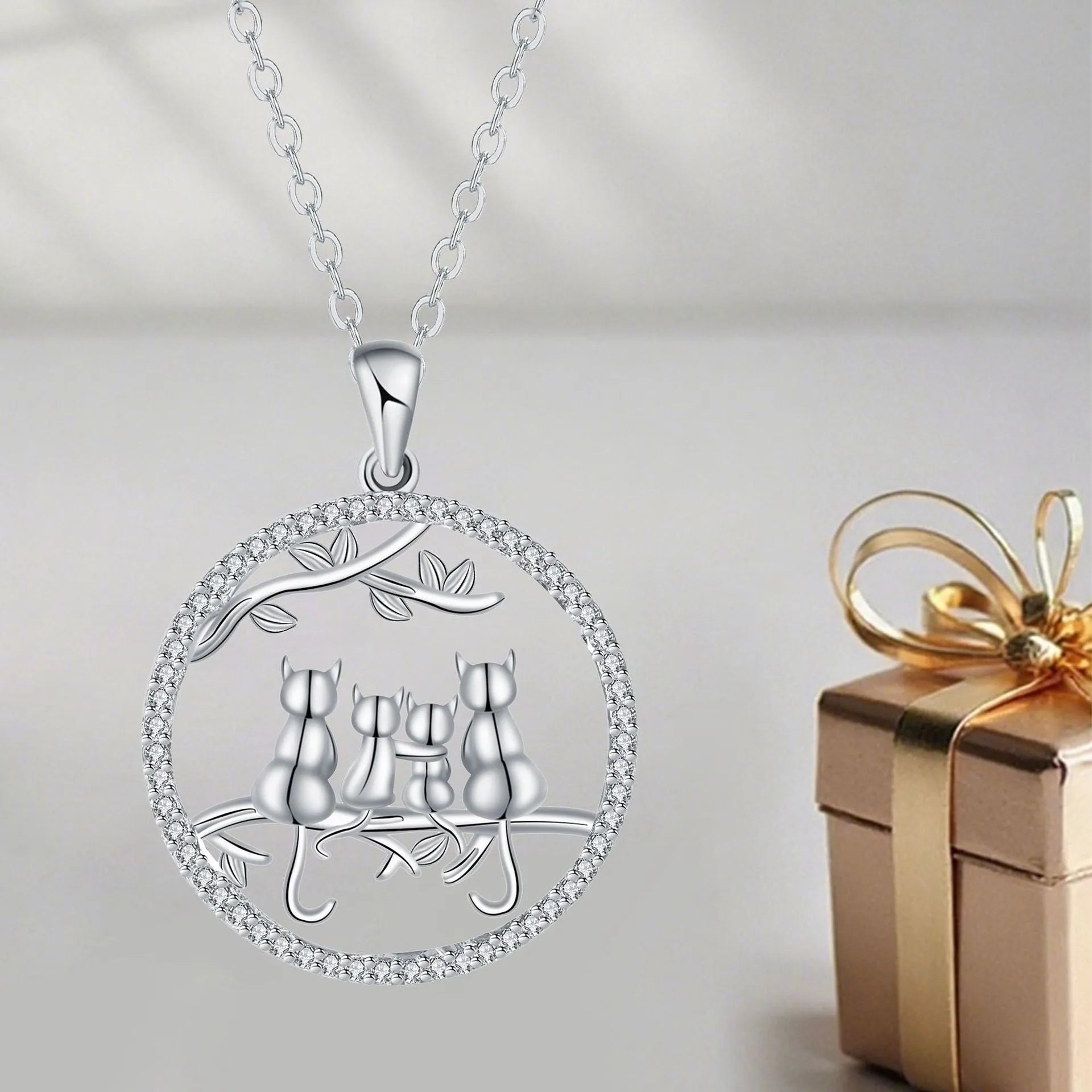 Women's copper necklace with four cat kitten pendants on cross chain, electroplated finish.