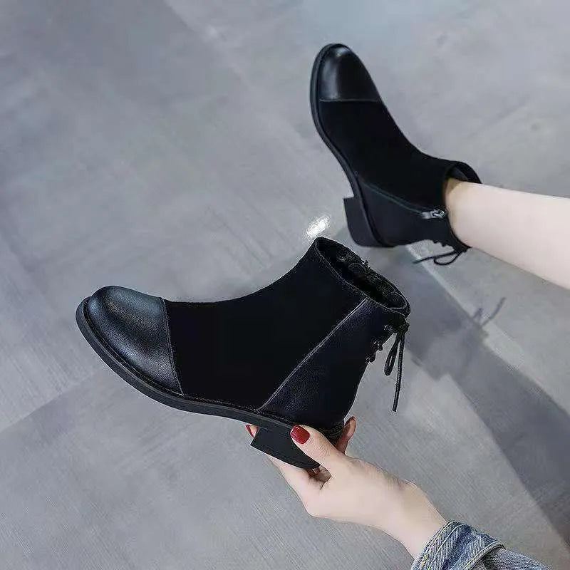 Women's black Martin boots with side zipper, round toe, and decorative bow detail
