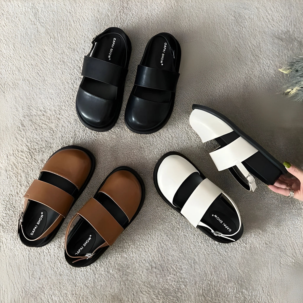 Retro women's sandals with a closed toe, ankle strap buckle, and platform sole in apricot colour.