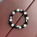 Natural stone opal agate Tai Chi bracelet with 10mm polished beads and black agate detail, unisex design on neutral background