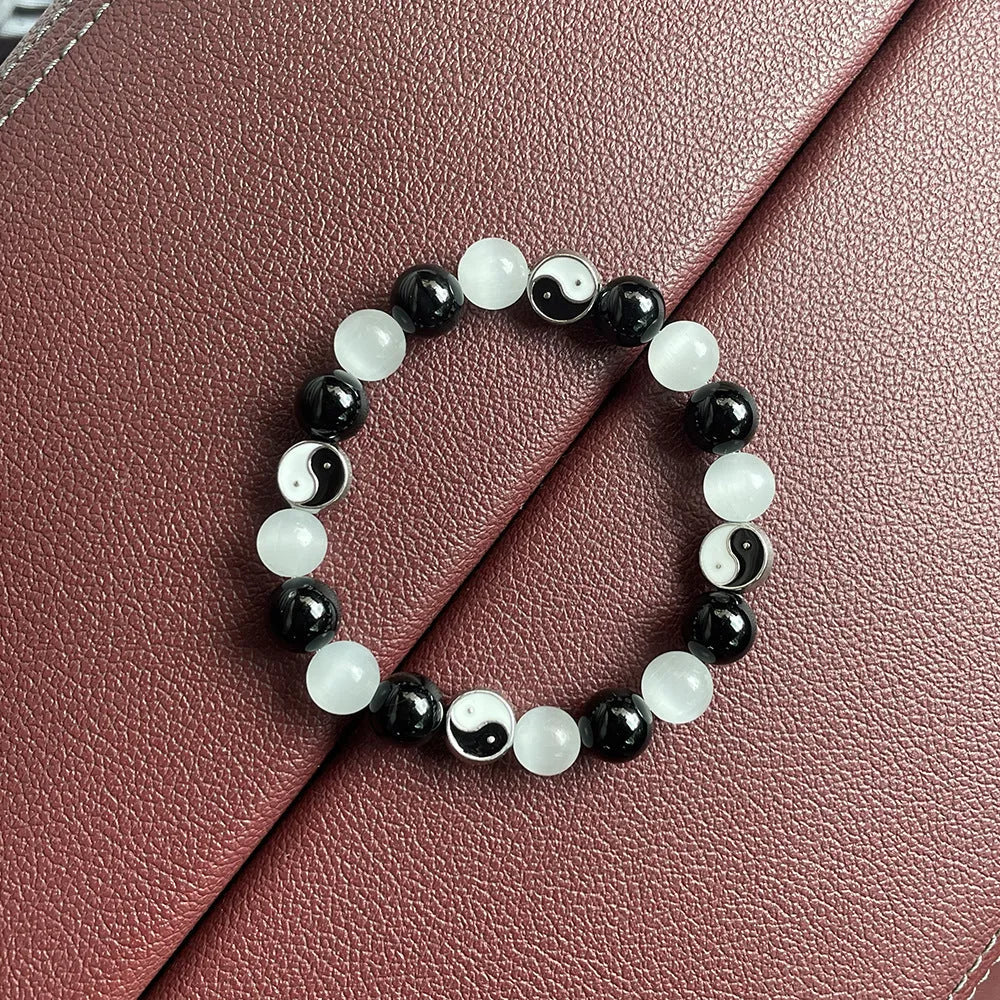 Natural stone opal agate Tai Chi bracelet with 10mm polished beads and black agate detail, unisex design on neutral background