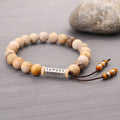 Wood colour stone bead bracelet with handmade construction on wrist