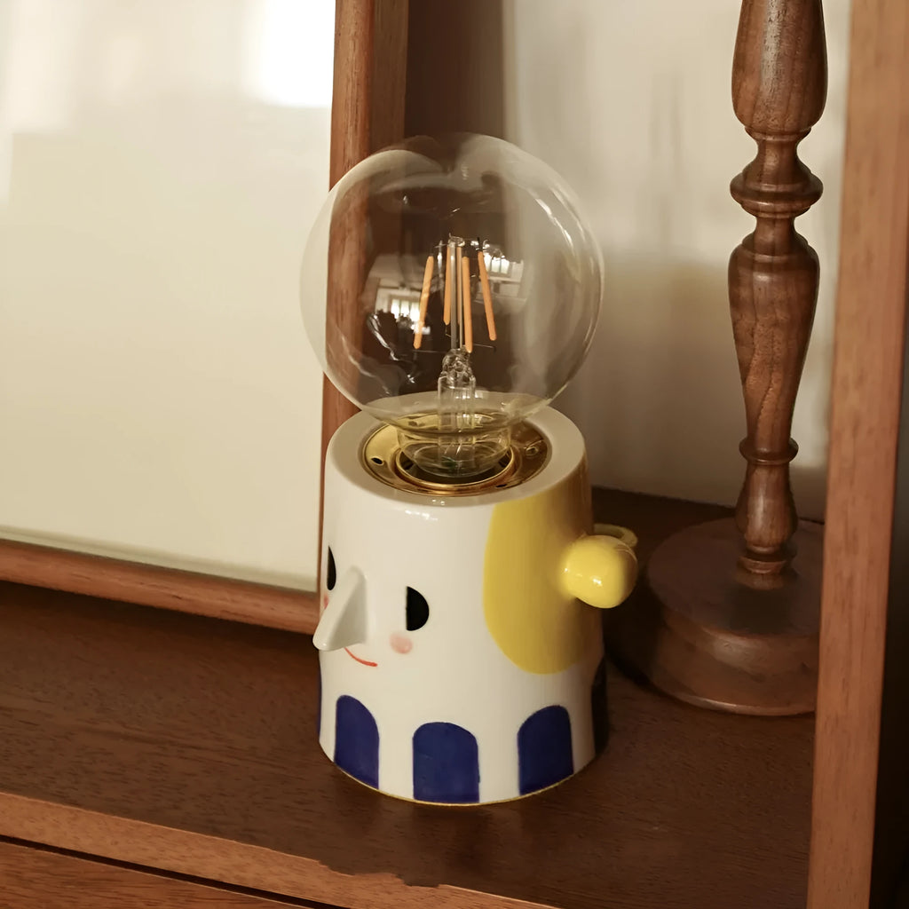 Handmade ceramic bedside lamp with spherical ball headlight shade on wooden nightstand