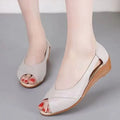 Women's peep toe rubber mid heel sandals with ankle buckle in black, side view