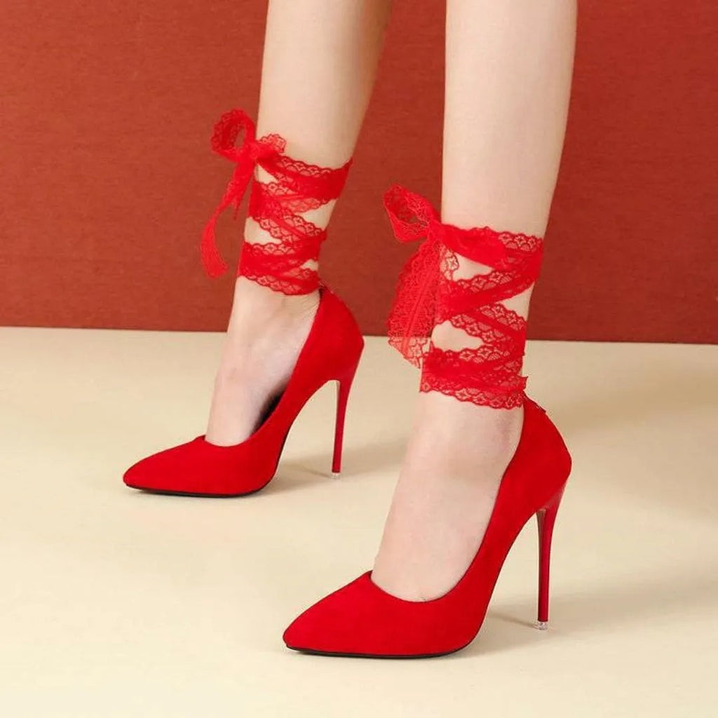 Black pointed toe stiletto pump with a thin strap and shallow mouth on a white background.