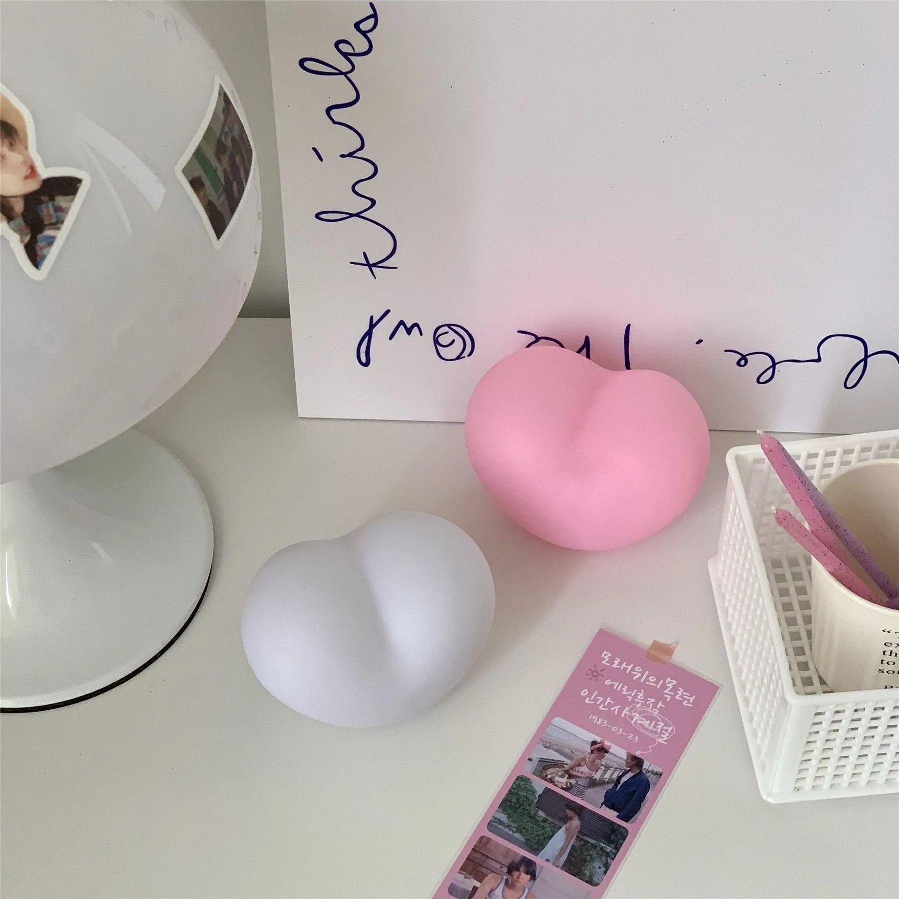 Pink and white vinyl atmosphere lamp creating a warm glow for decorative lighting.