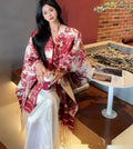 Women's fashion scarf cape with tassel detailing in polyester fabric, shown draped as a shawl