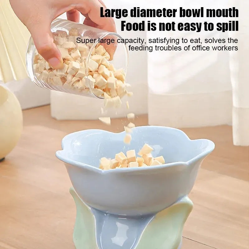 Blue ceramic pet bowl with floral pattern, raised on a non-slip base for cat or small dog feeding.