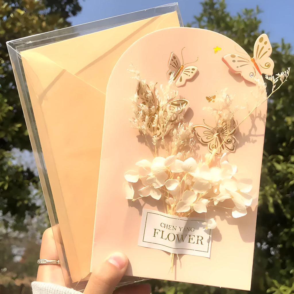 Handmade 3D boxed birthday card with butterfly shape and artificial flowers on coated paper.