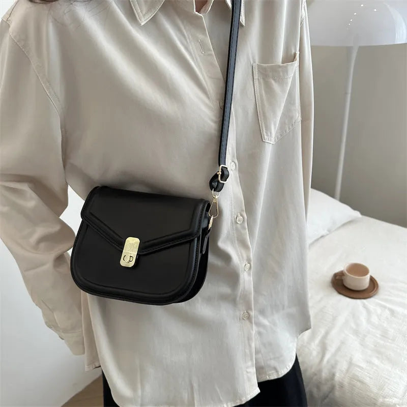 PU leather soft shell messenger bag with clamshell opening in a horizontal square shape.