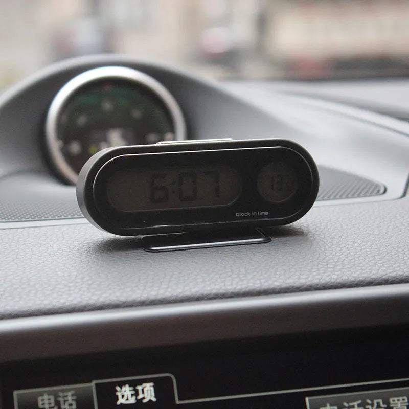 Black electronic car clock thermometer with luminous LED display showing time and temperature