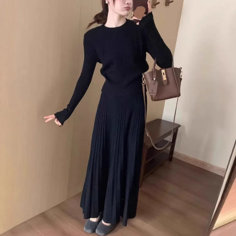 Women's dark grey knitted dress suit set with sweater and skirt showing 3D knit pattern and collage stitching
