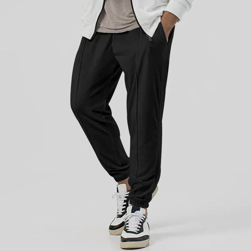 Men's casual track sweatpants in cotton blend fabric showing loose tapered straight-leg design in Army Green colour