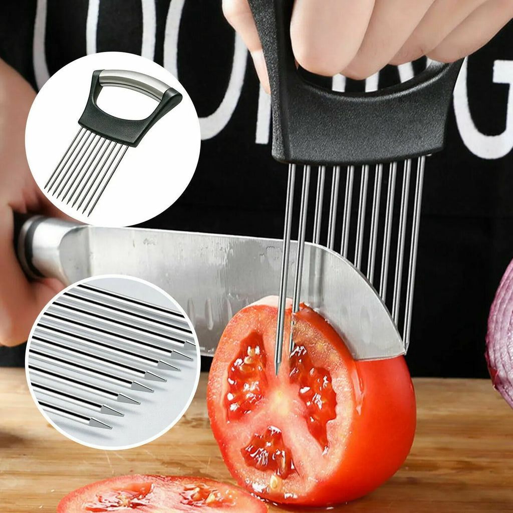 Stainless steel onion holder slicer with non-slip base on a kitchen counter, holding a tomato for slicing