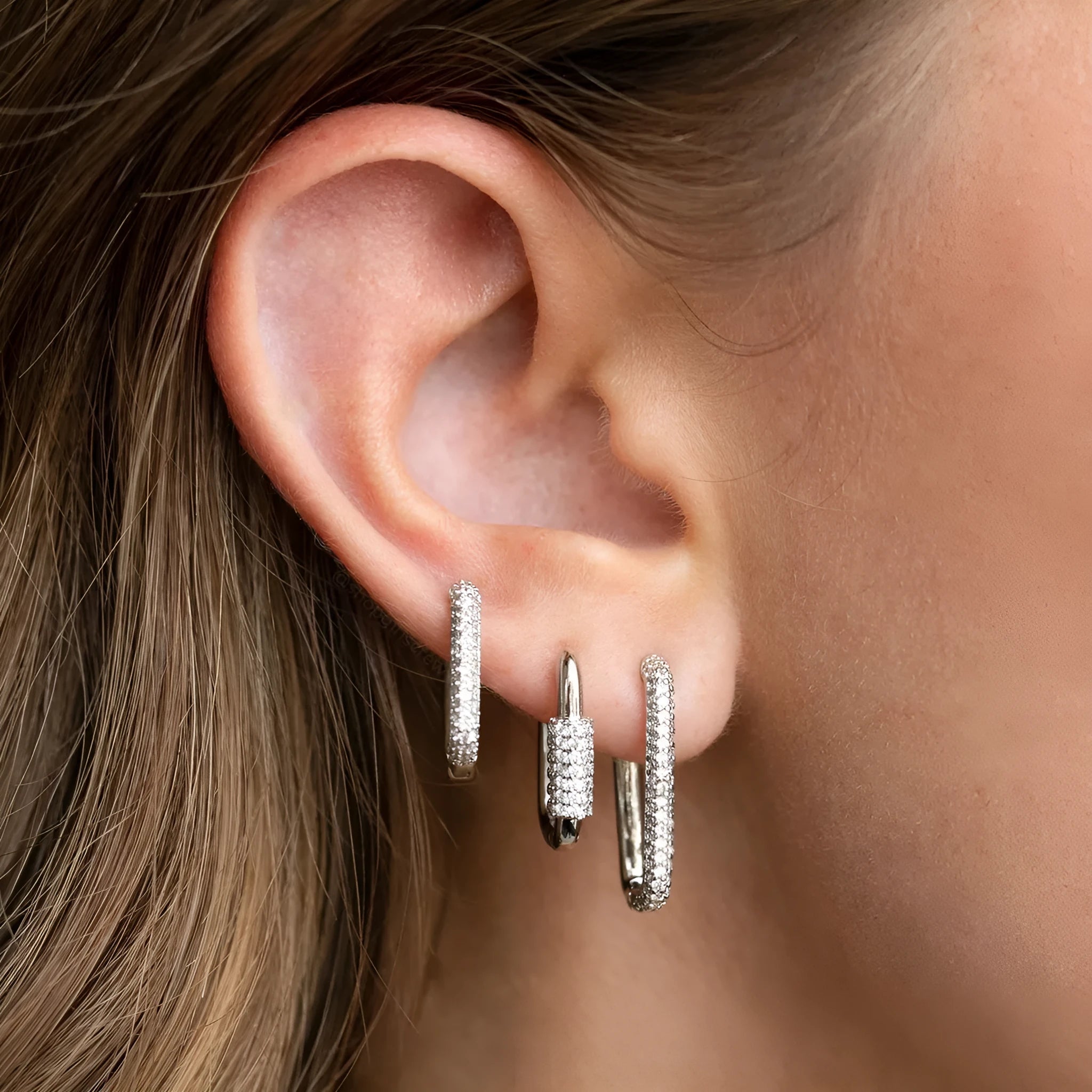 Three geometric ear clips with micro inlaid zircon detailing on copper in gold and white colours