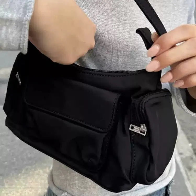 Black lightweight PU shoulder bag with two pockets and side-line detailing.