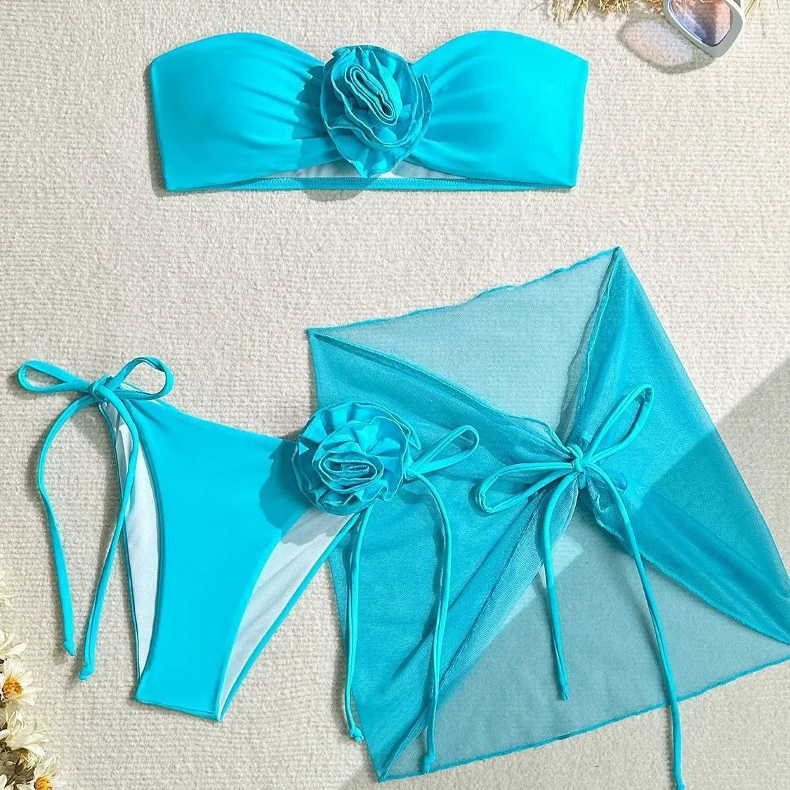 Women's pink tube top swimsuit with a large 3D flower tie and a matching detachable skirt.