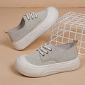 Women's camel suede platform loafers with round toe and front lace-up on a flat rubber sole.
