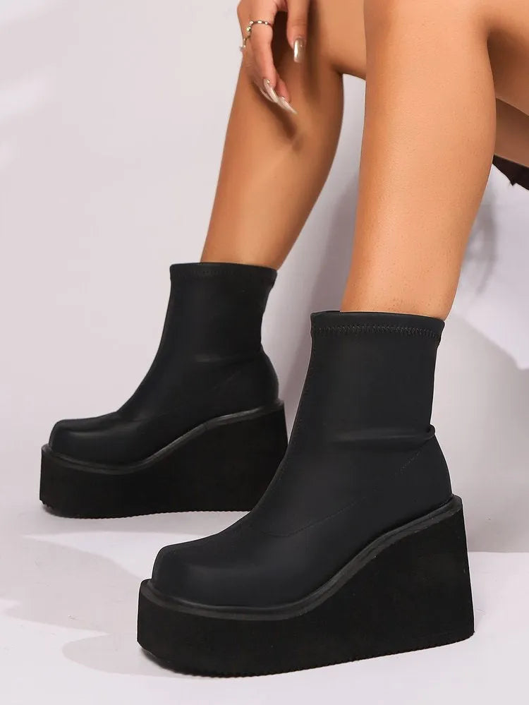 Plus size women's platform boots with wedge heel and round toe in black leather