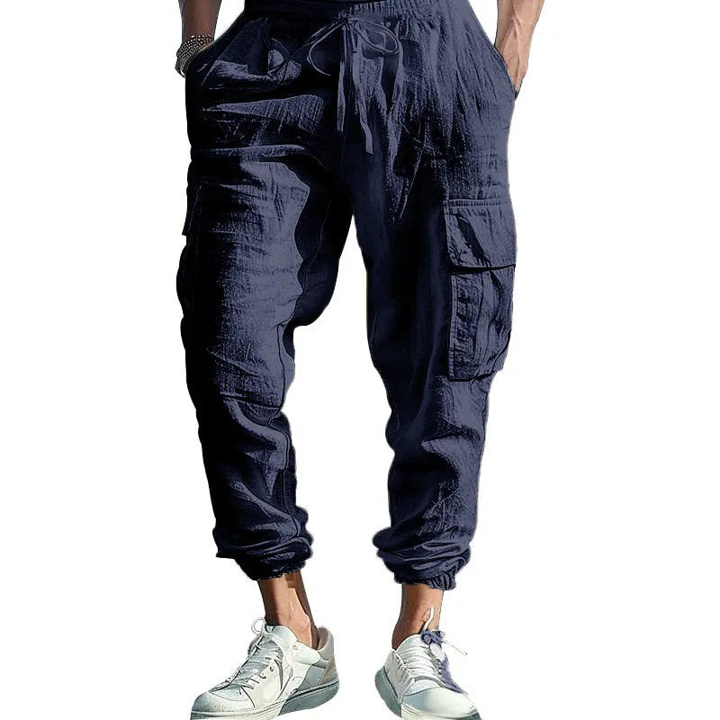 Men's loose linen trousers in Army Green with ankle ties and a multi-pocket tether detail.