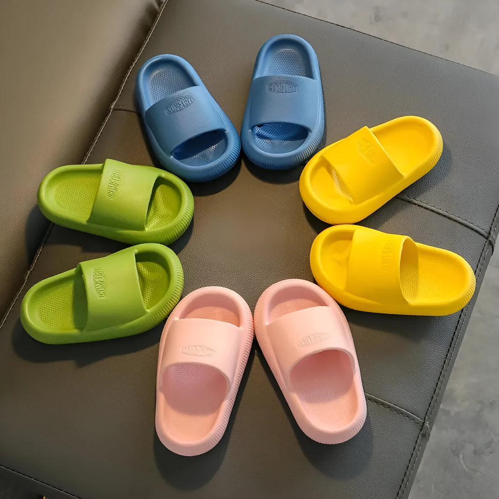 Children's bright coloured EVA slippers with textured non-slip soles on a white background.