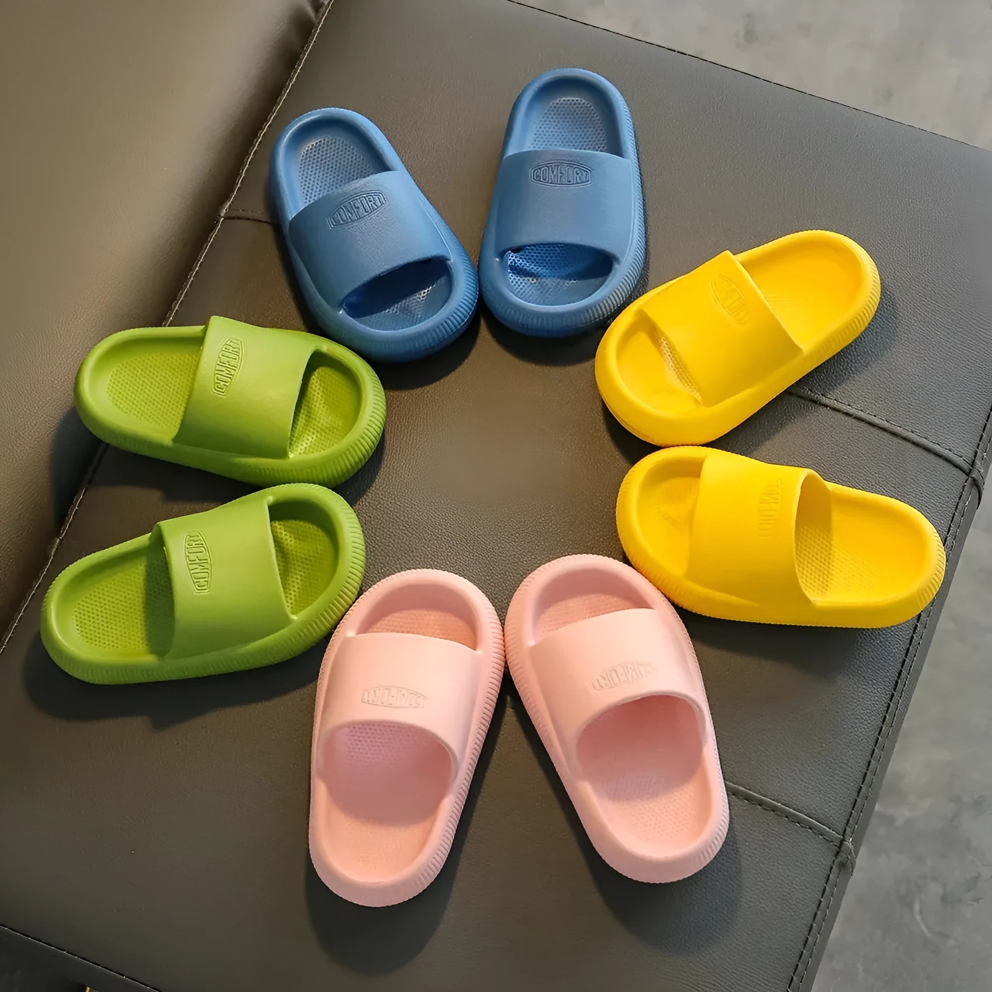 Children's bright coloured EVA slippers with textured non-slip soles on a white background.