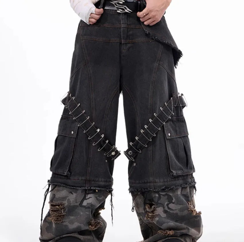 Men's grey cotton jeans with camouflage pattern splicing and decorative pin and ribbon details on the legs.