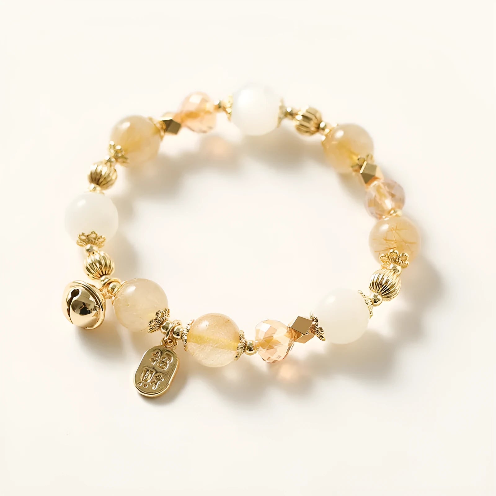 Gold electroplated rutilated quartz bracelet with ringing bell design in Korean style