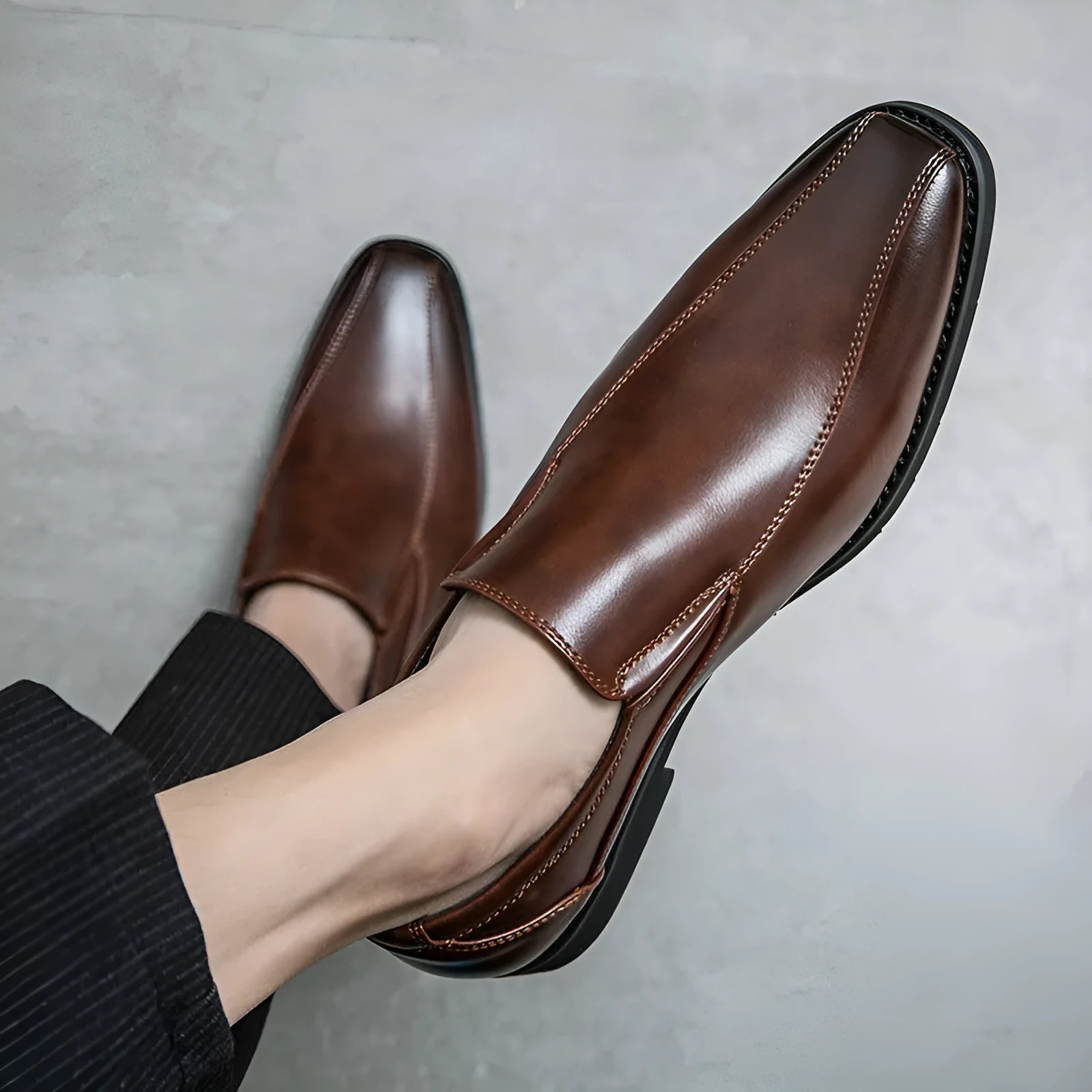 Men's black pointed patent leather shoes with leather lining and flat heel on a neutral background