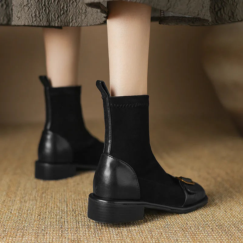 Black women's lace-up Martin boots with low heel and decorative belt buckle stitching on a white background.