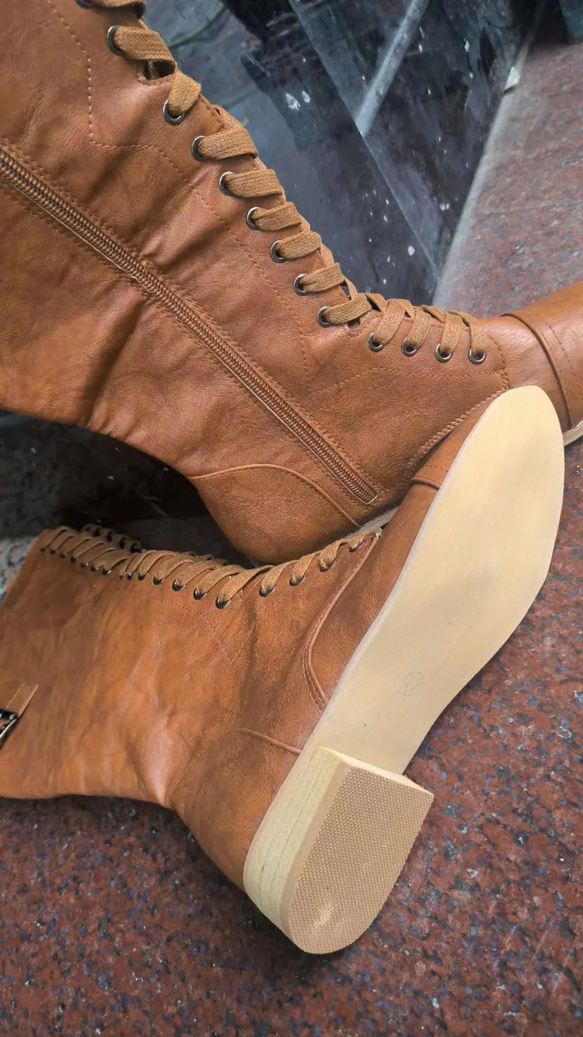 Women's black knight-style ankle boots with a cross-strap design across the front.