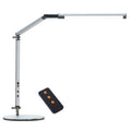 Aluminium LED desk lamp with a stainless steel clip mount and remote control on a wooden desk.