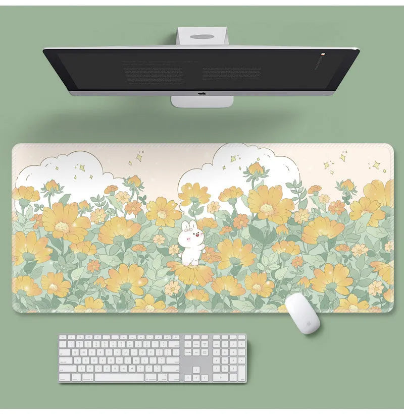 Large floral pattern mouse pad with non-slip rubber base on a wooden desk.