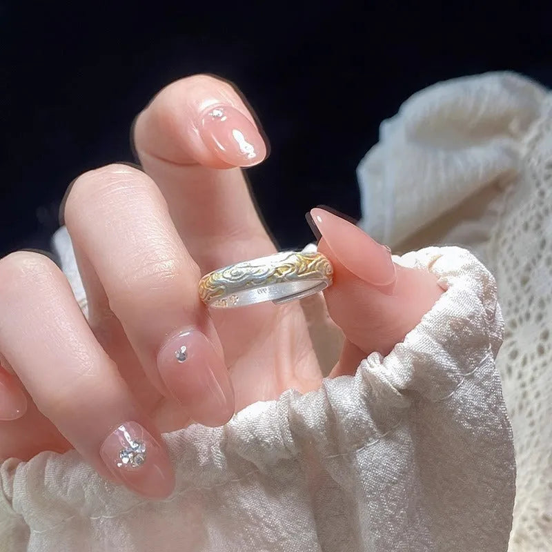 Geometric white copper open ring with silver and gold electroplated Xiangyun pattern.