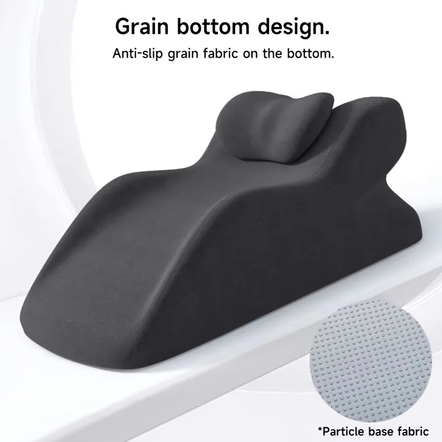 A stomach sleeper pillow shown in light grey, designed for prone positions and reading in bed.