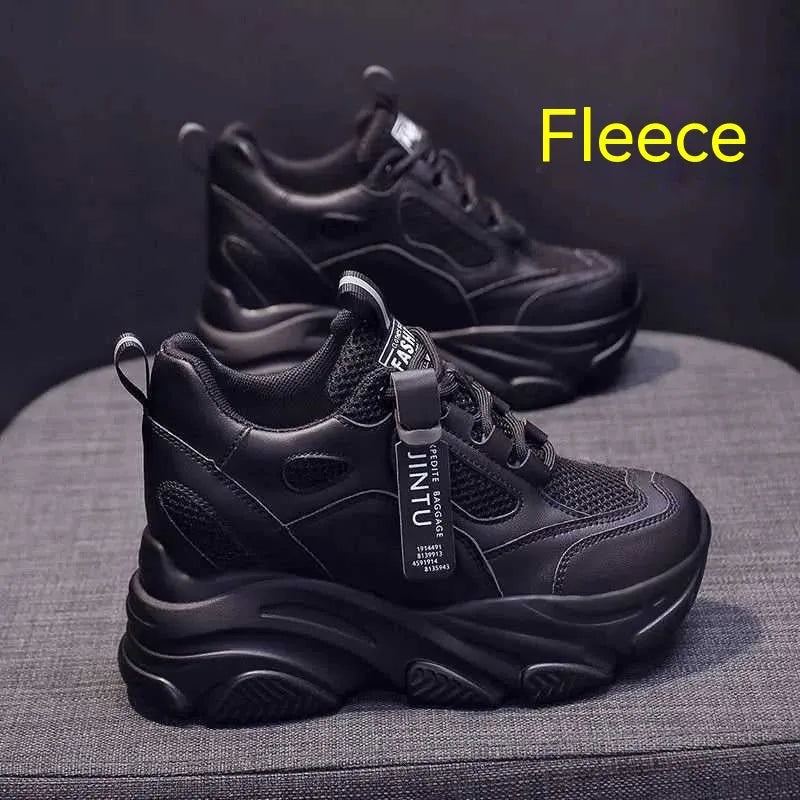 Women's black mesh platform shoes with a hollow-out design and a velvet lining on display.