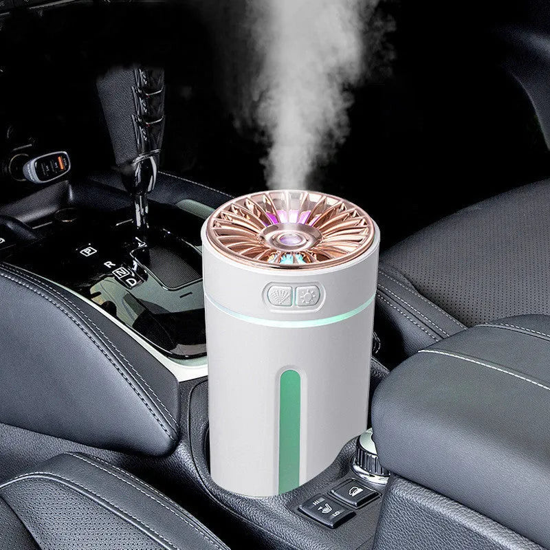 Black wireless ultrasonic humidifier with LED lights sitting in a car cup holder.