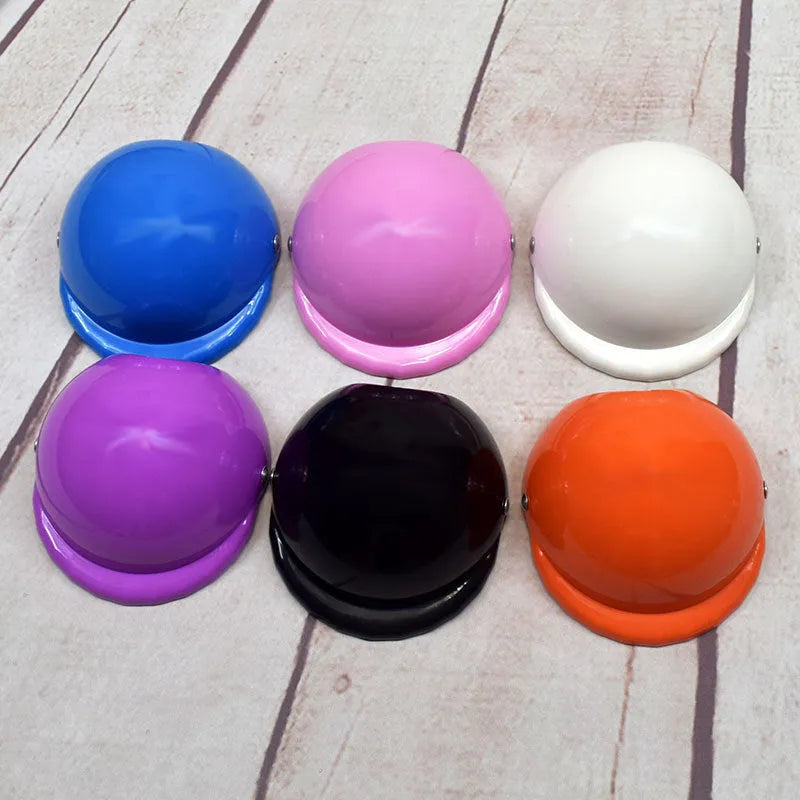 Solid colour plastic motorcycle cap helmet for dogs in pink, shown in small size.