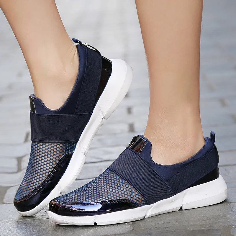 Women's blue low-top casual sneakers with mesh inside on a hard floor surface