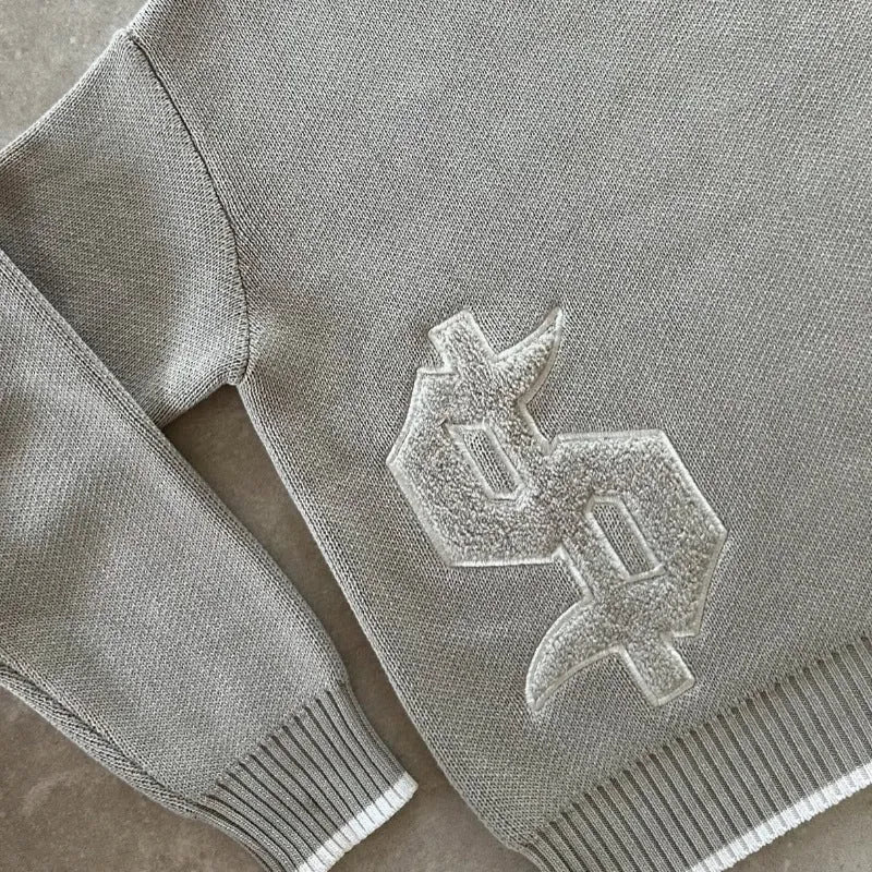 Grey loose-fitting jacquard knitwear pullover coat with long sleeves for autumn winter wear.