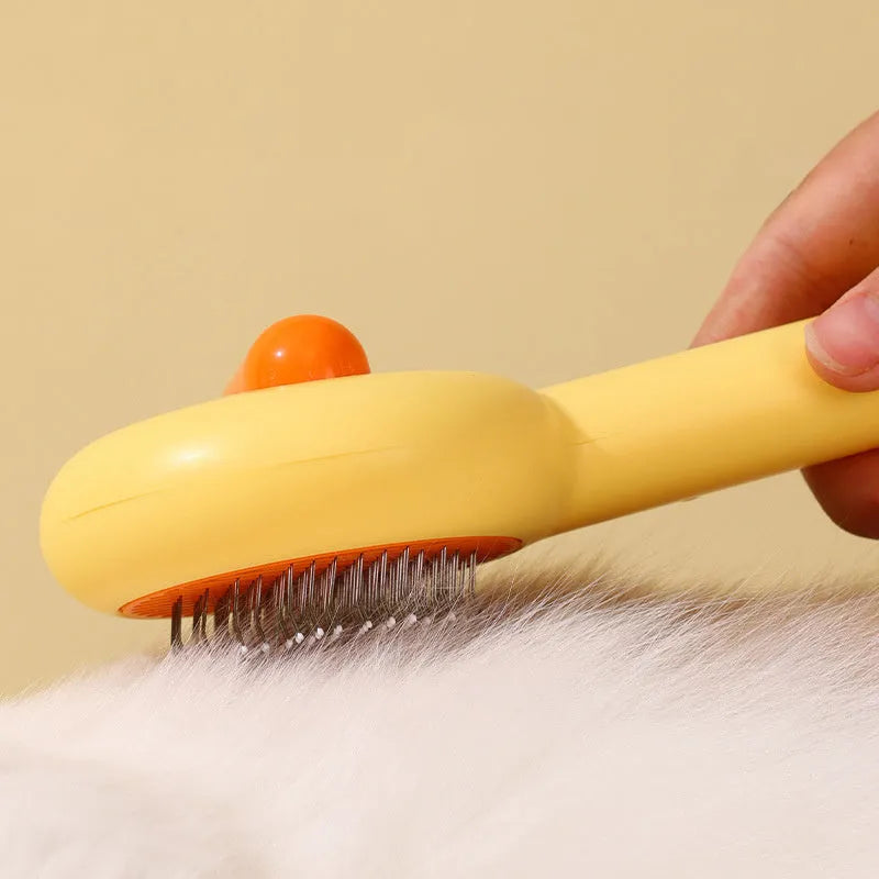 Yellow duck-shaped pet comb with open-section design and floating needle teeth for cat and dog grooming