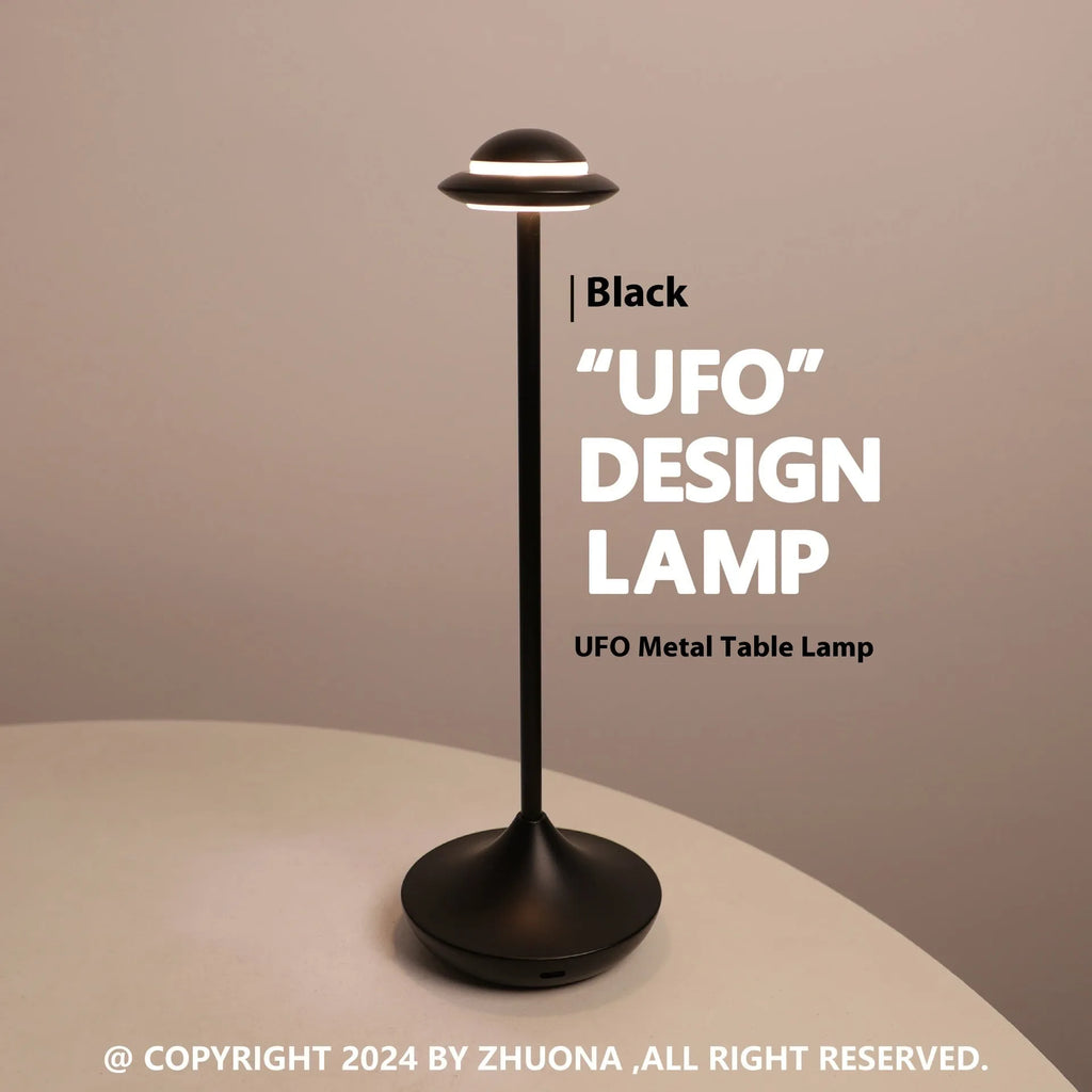 Modern black UFO-shaped rechargeable table lamp with touch-sensitive dimming controls on a wooden desk.