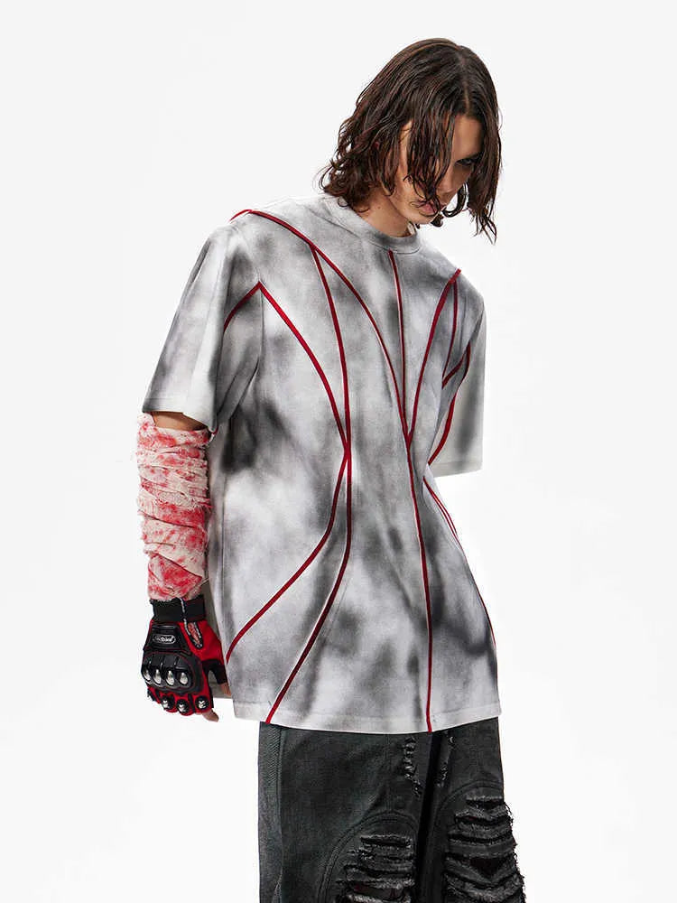 Padded shoulder short sleeve t-shirt with textured line patchwork design and round neck.