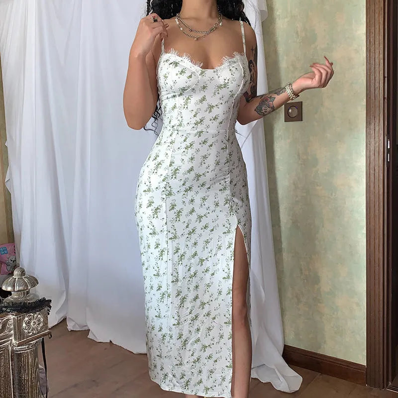 Women's long dress with lace flower print, high split, and suspender straps in blue colour.