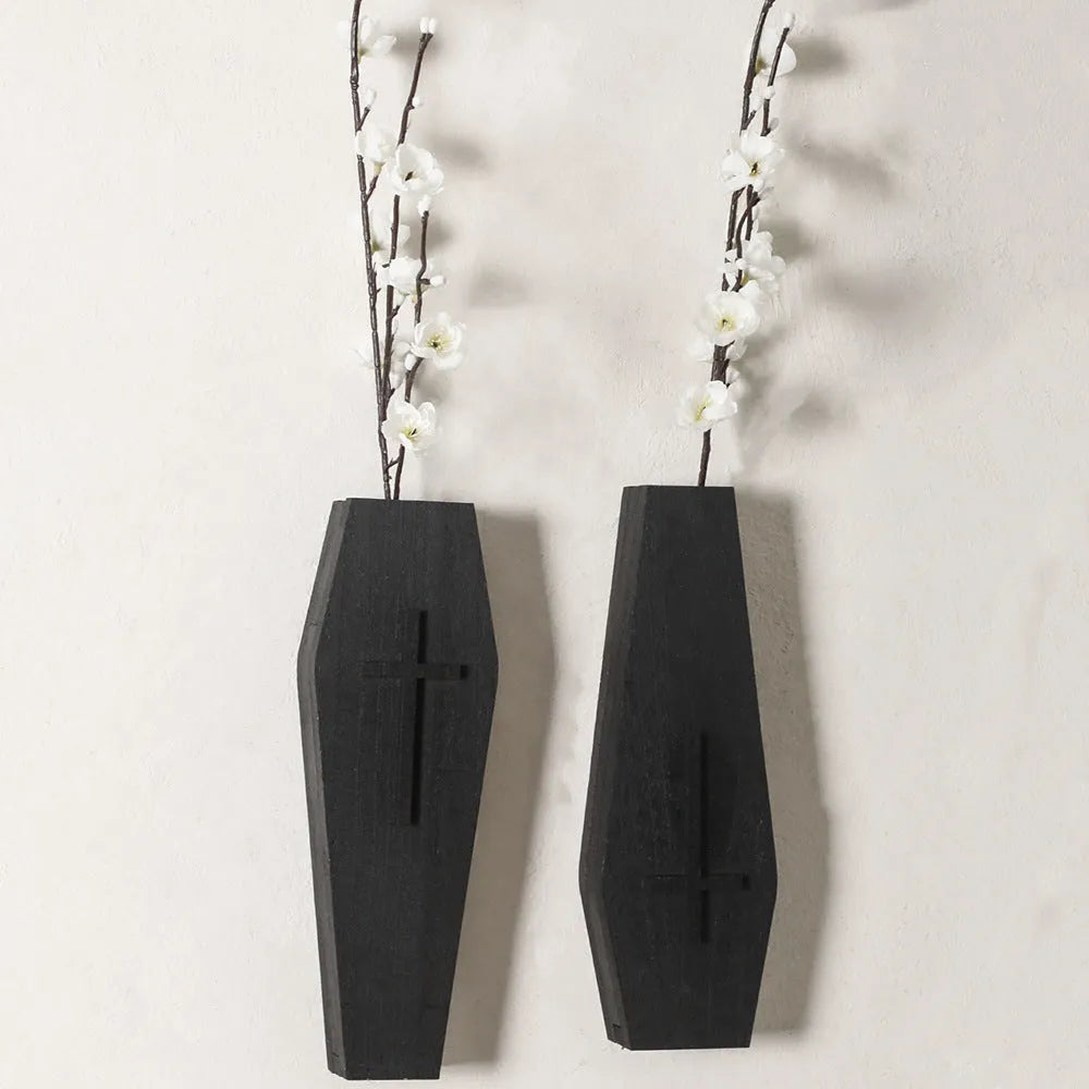 Black cross-shaped wooden wall vase shelf with a compact 27 cm ledge for holding a small vase or ornament