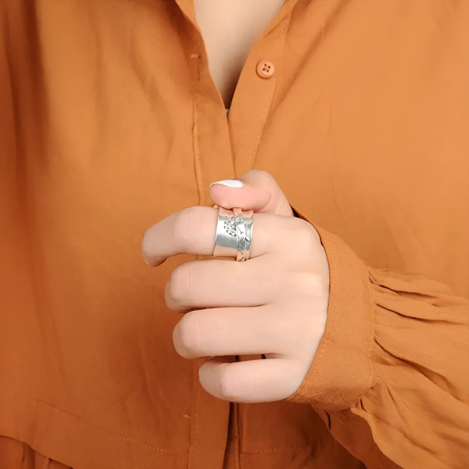 Silver electroplated rotatable flower ring showing floral design on alloy band