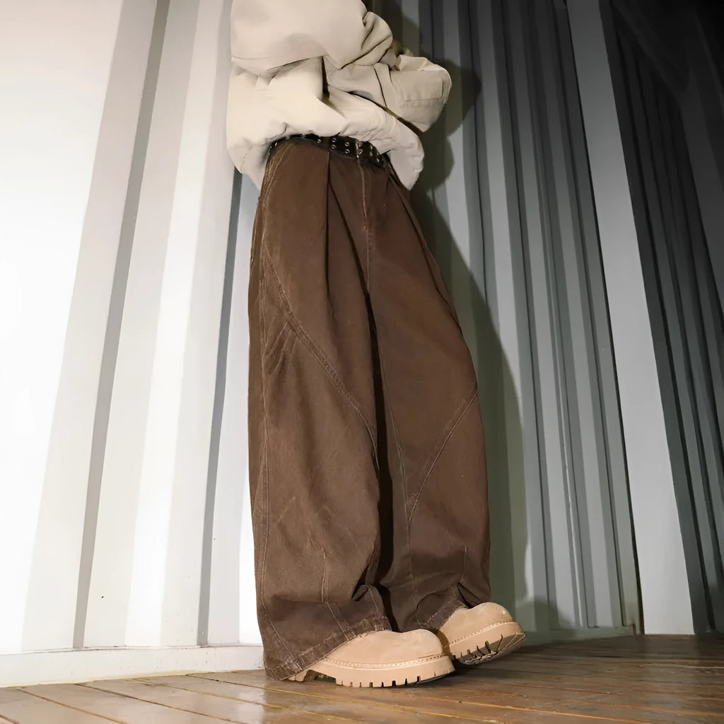 Men's pleated straight leg loose fit trousers in a black stripe pattern, showing front and side details.