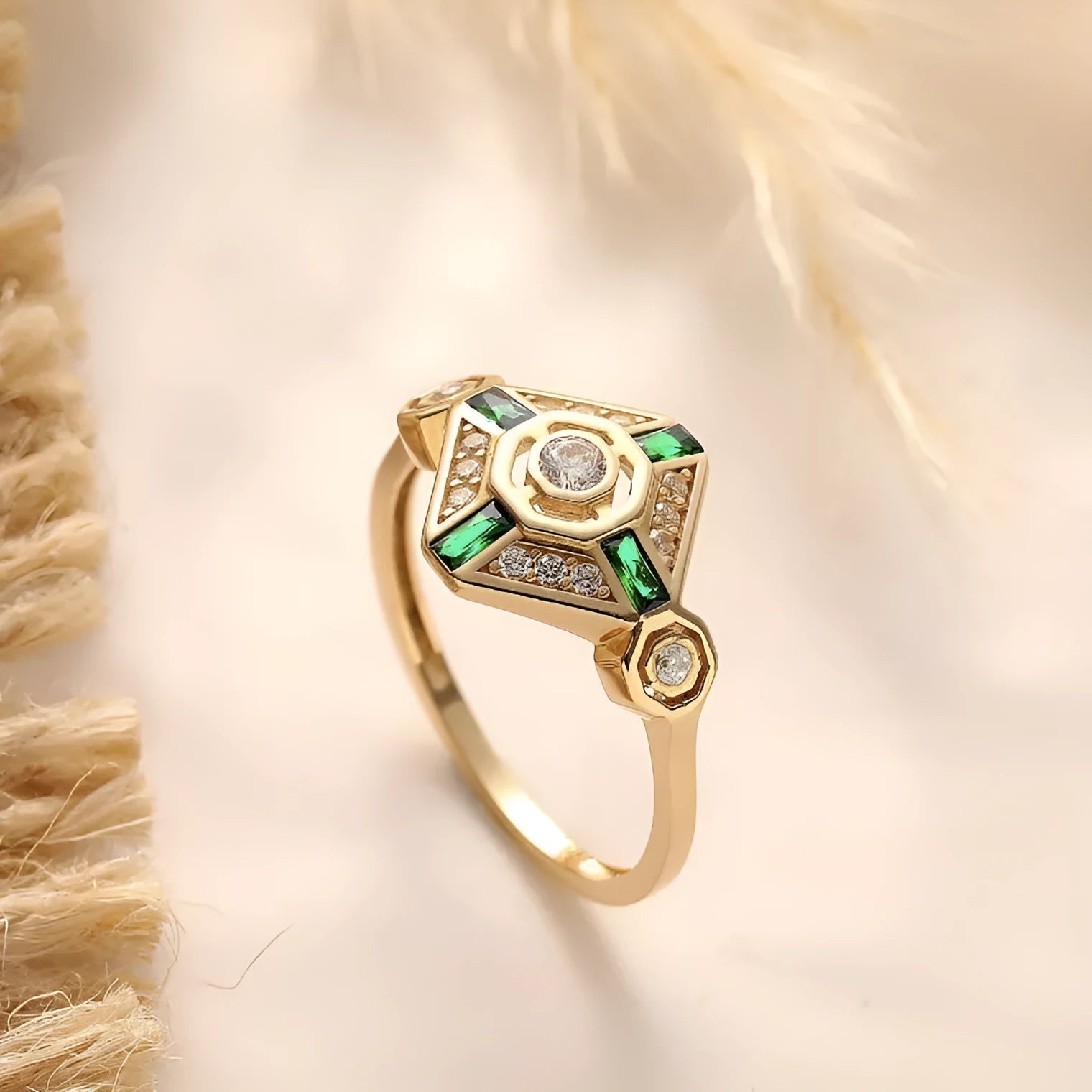 Square geometric women's ring with green diamond colour on a hand.