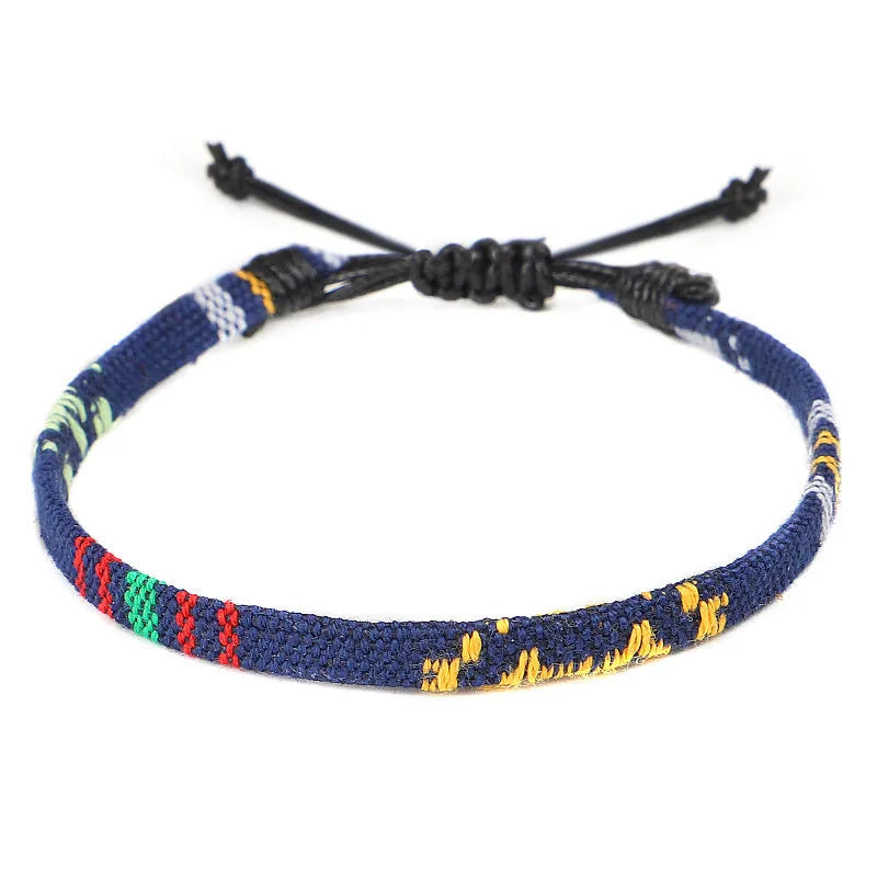 Hand woven rainbow colour bohemian style cloth anklet on a neutral background