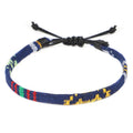 Hand woven rainbow colour bohemian style cloth anklet on a neutral background